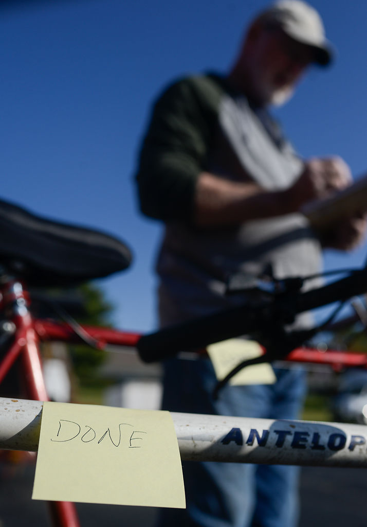 Dan Steska does a final check on the paperwork before sending off three bicycles